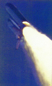 The glow of the flame from the SRB